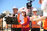 Three people wearing high-vis vests. 