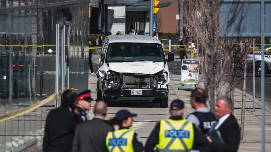 Police are seen near the damaged vehicle involved in the incident.