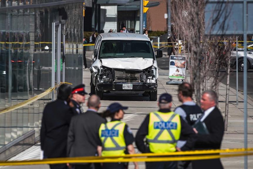 Police are seen near the damaged vehicle involved in the incident.