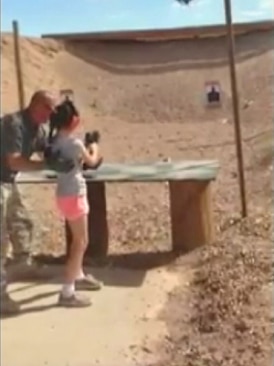 A nine-year-old girl fires an Uzi