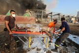 An injured man is transported on a stretcher following an explosion in Beirut's port area.
