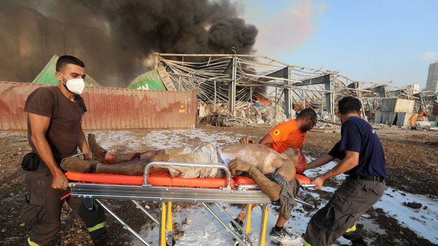 An injured man is transported on a stretcher following an explosion in Beirut's port area.