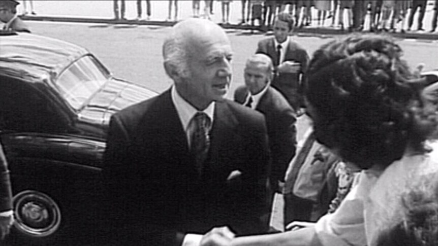 William McMahon shakes hand with unknown person in street