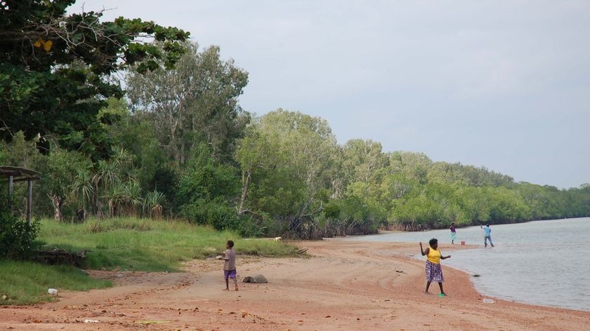 Aurukun residents fish on the banks of the Archer River.