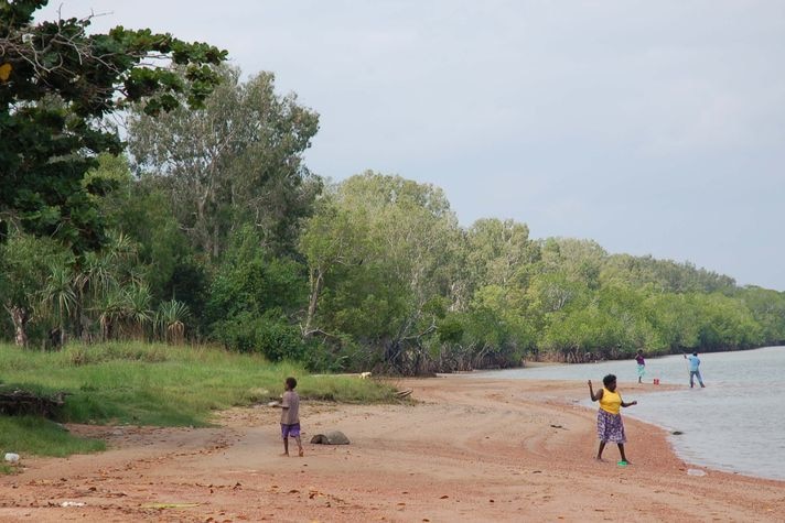 Aurukun residents fish on the banks of the Archer River.