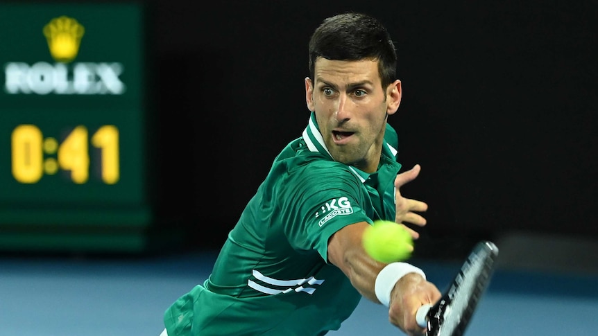 Novak Djokovic stretches out to hit a backhand return against Alexander Zverev at the Australian Open.