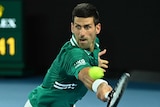 Novak Djokovic stretches out to hit a backhand return against Alexander Zverev at the Australian Open.