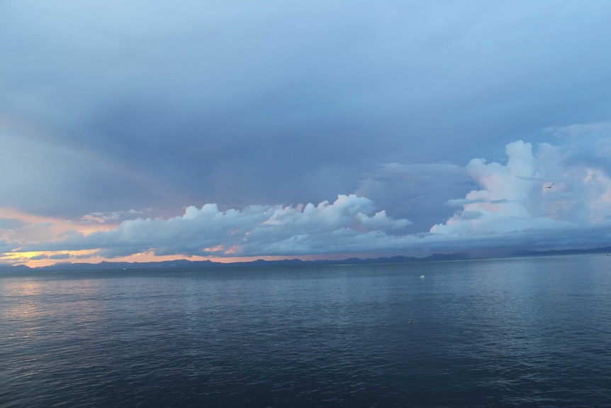 Wide-shot a dark-blue ocean and clouds in Fiji.