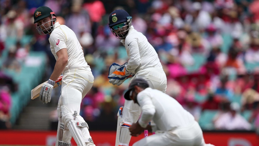 Shaun Marsh looks behind him as the slip fielder stoops to take the catch