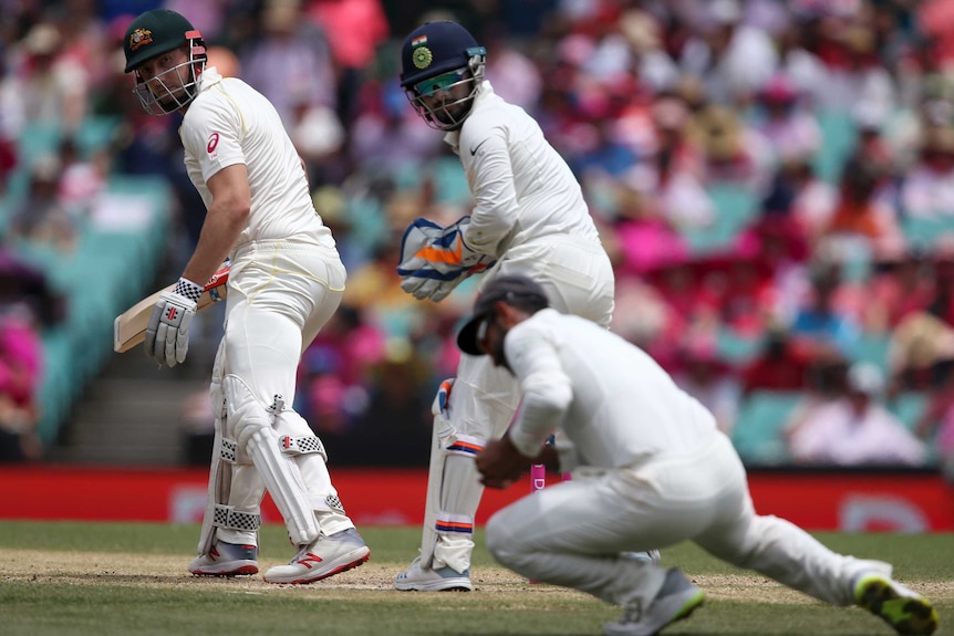 Shaun Marsh looks behind him as the slip fielder stoops to take the catch