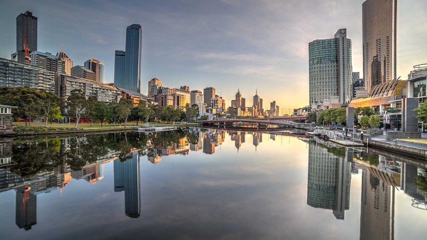 The Melbourne CBD is perfectly reflected in the stillness of the Yarra River.