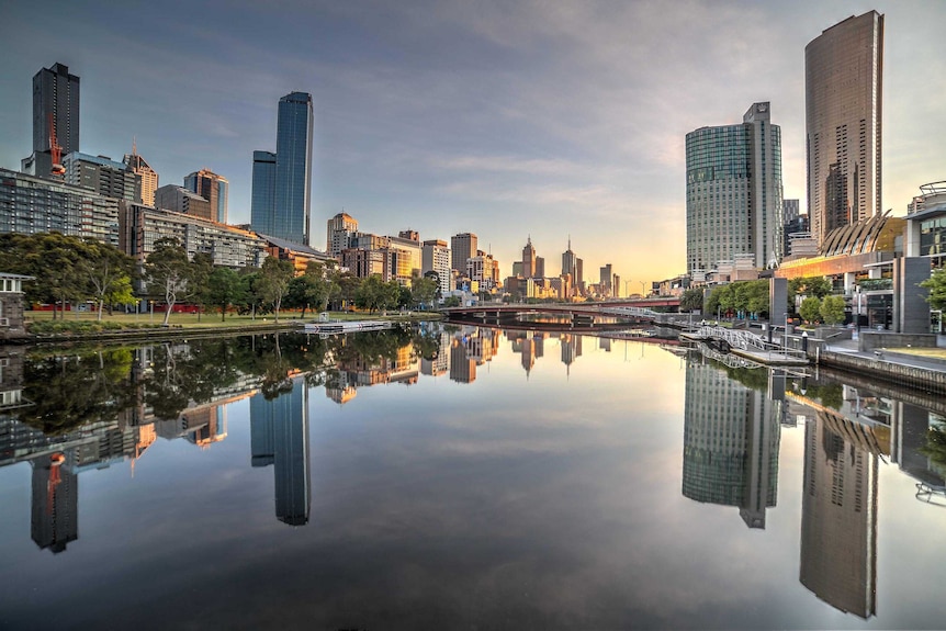 The Melbourne CBD is perfectly reflected in the stillness of the Yarra River.