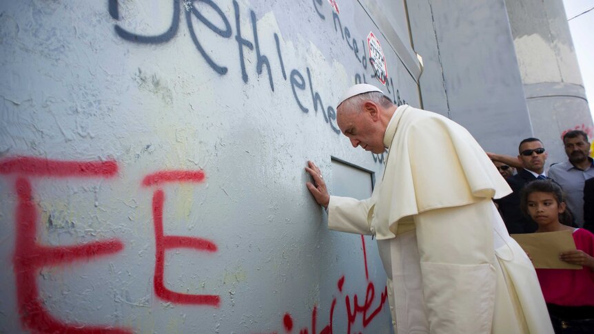 Pope Francis praying at Israel's separation barrier