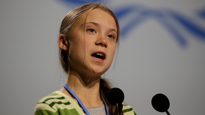 Swedish climate activist Greta Thunberg speaking into a microphone.