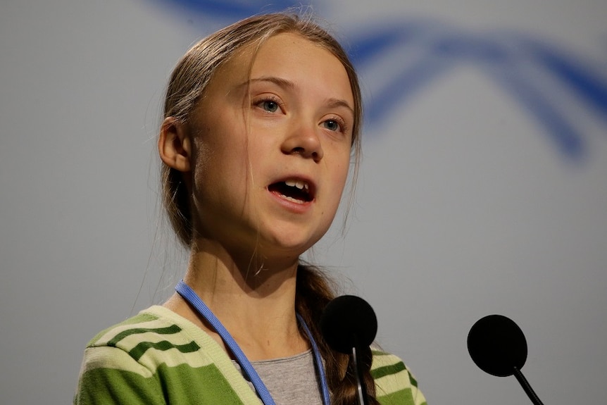 Swedish climate activist Greta Thunberg speaking into a microphone.