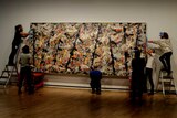 Staff at the National Gallery of Australia rehang Jackson Pollock's Blue Poles artwork.