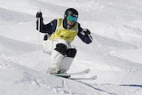 Skiier goes down a slope