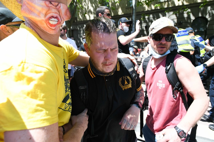 A OC spray affected protester is seen during an anti-lockdown protest in Melbourne.