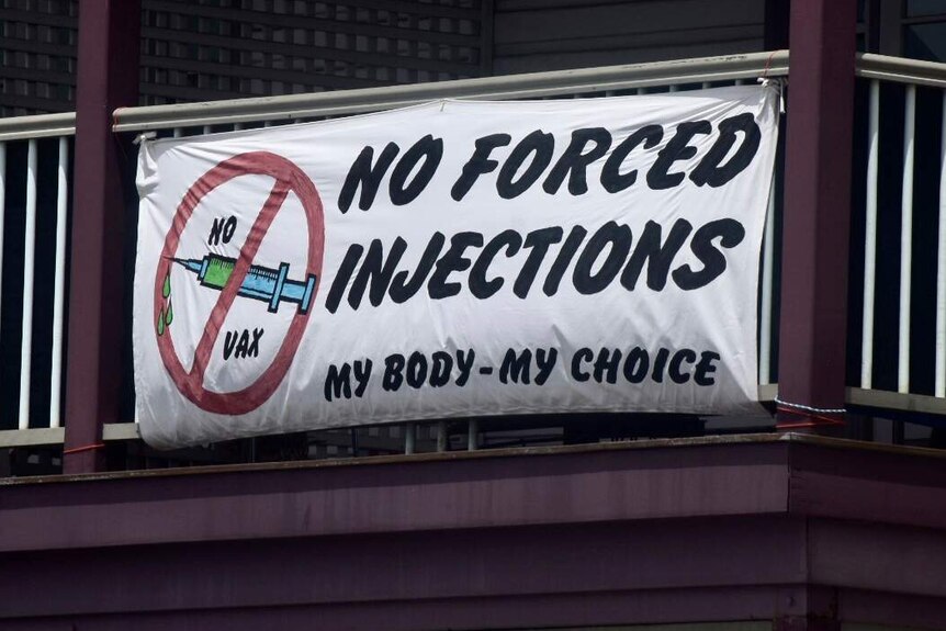 Along the main street of Mullumbimby, a sign reads 'no forced injections'.