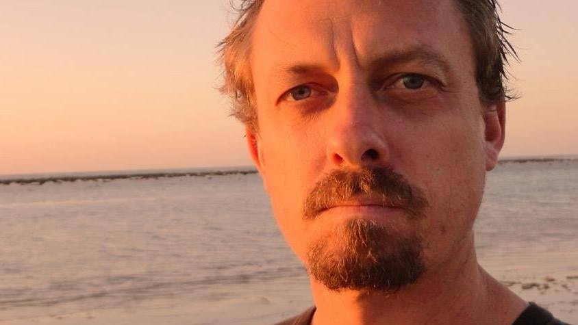 Man standing in front of beach