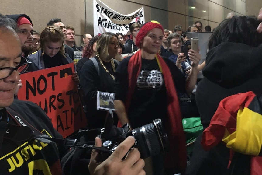 More than 100 protesters chant anti-Pauline Hanson slogans in front of the ABC building.