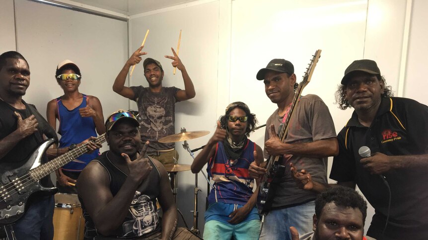 Eight young Indigenous men in the K Squad youth band from the remote Arnhem Land community of Ngukurr