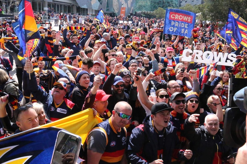 Crows fans crowd Federation Square ahead of the grand final.