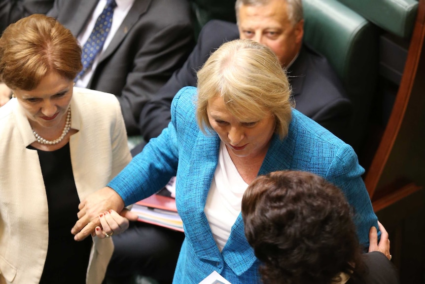 MP Christine Fyffe being escorted to the Speaker's chair