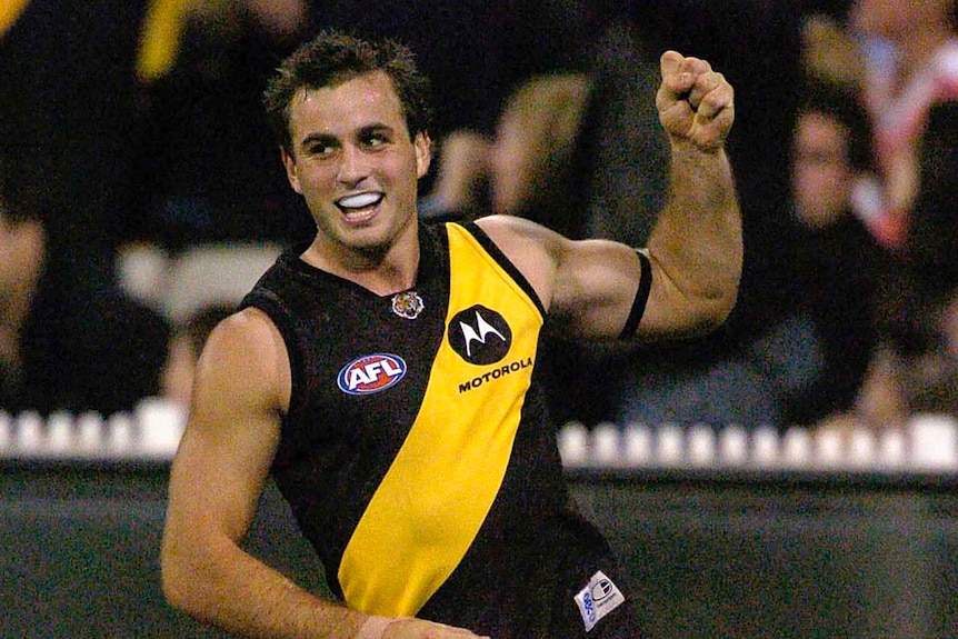 Ty Zuntuck wearing black and yellow and pumping his fist in the air as he runs during a game.