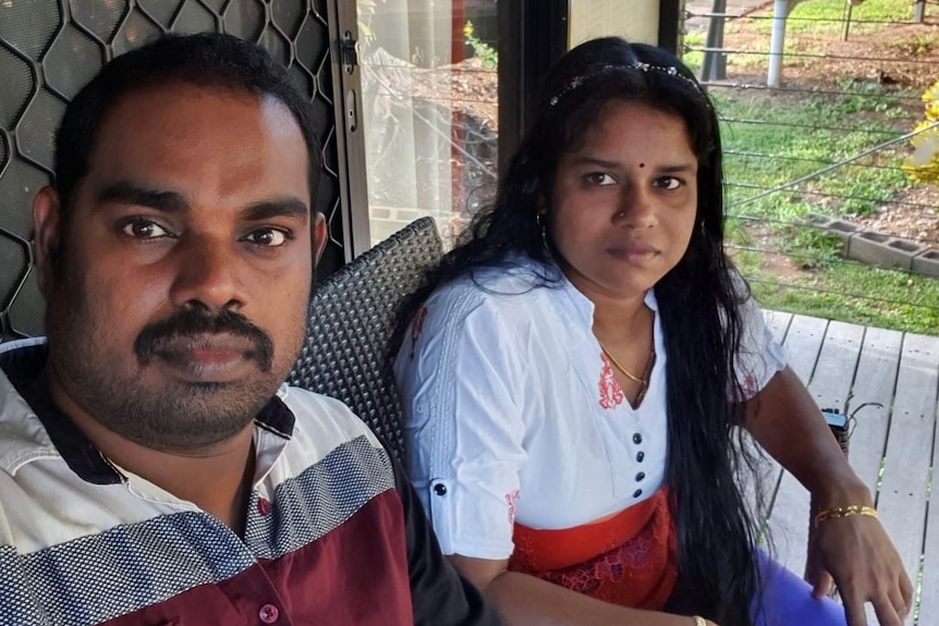 Parmika Sutharsan and Kirubakaran Rasanayagam sit in chairs on a small balcony in Darwin's immigration detention centre.