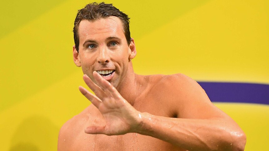Gallant effort ... Grant Hackett waves to the crowd after his 200 metres freestyle semi-final in Adelaide