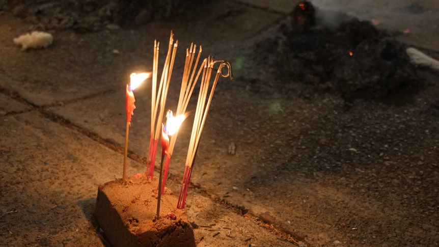 Incense burning on cement during Chinese festival.