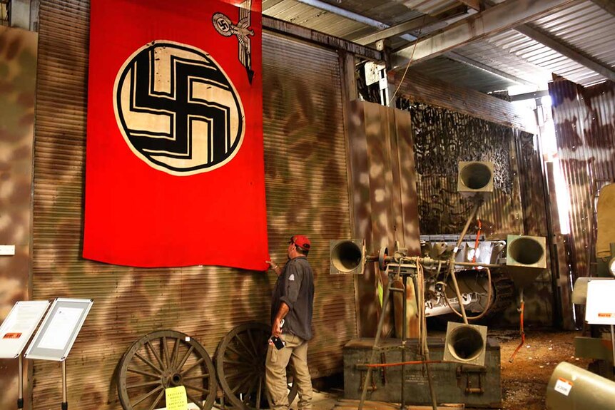 A Nazi flag hanging from a wall.