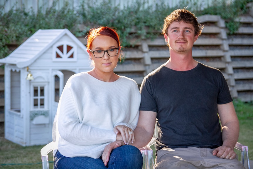 Daniel Linwood comforting his wife Jessica at their Toowoomba home.