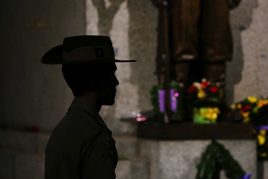 The silhouette of an Australian soldier paying respects.