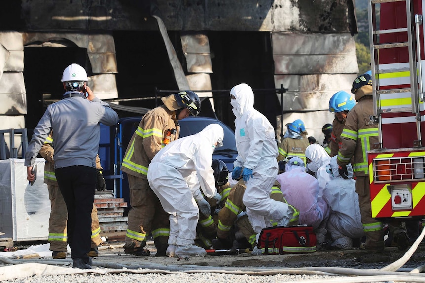 Emergency workers assess the site of a fire in South Korea