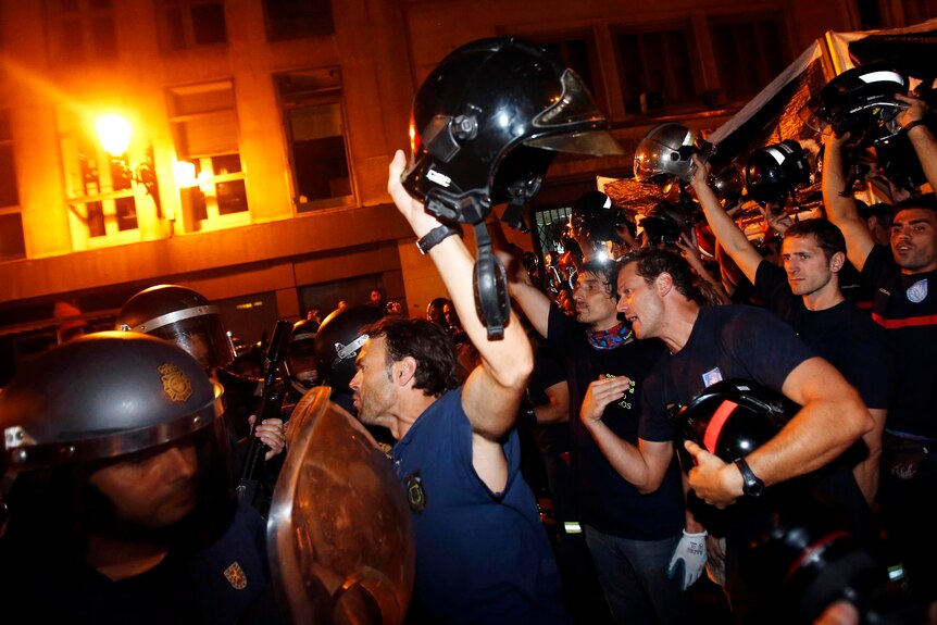 Firemen confront Spanish National Police during a protest against government austerity measures.