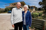John and Trish Hagan pose outside their house.