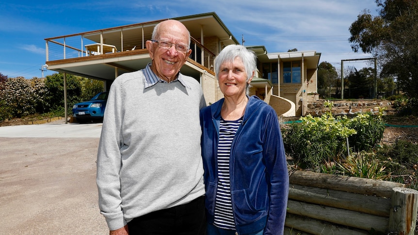 John and Trish Hagan pose outside their house.
