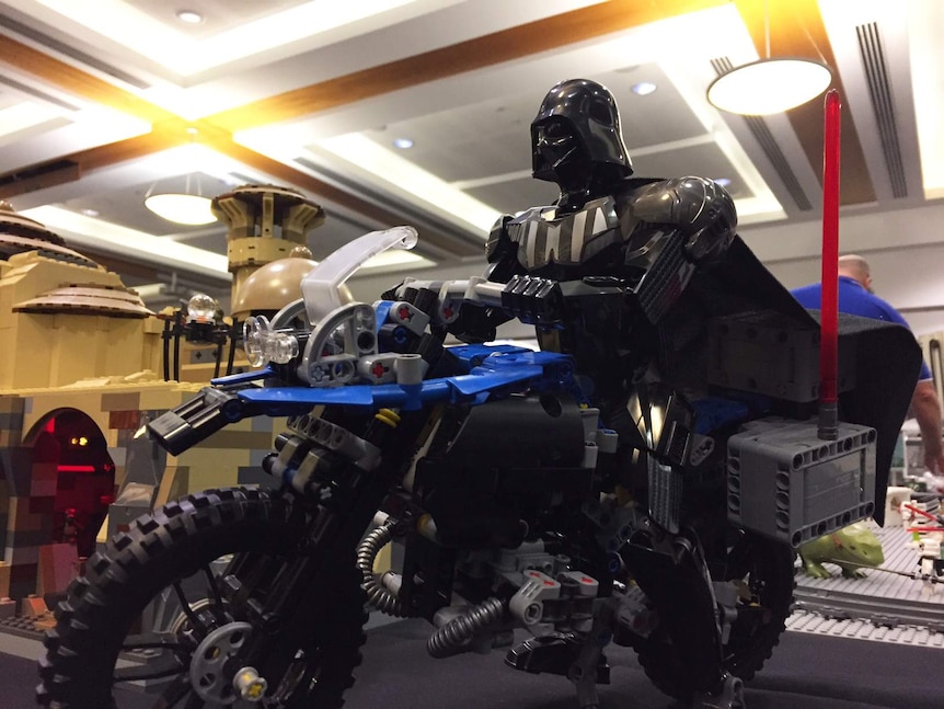 A Lego Darth Vader riding a motorbike.