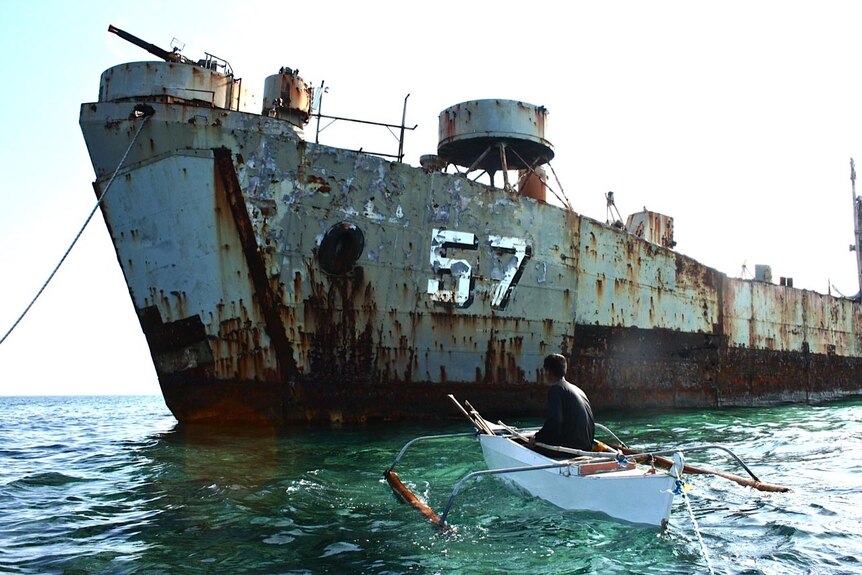 An islander from the Spratly Islands approaches the wreck of the Philippine Navy ship, Sierra Madre.