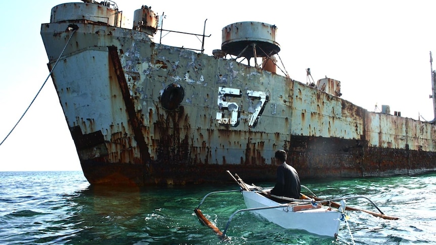 An islander from the Spratly Islands approaches the wreck of the Philippine Navy ship, Sierra Madre.