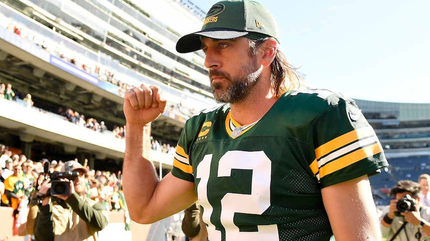 Aaron Rodgers, wearing a Green Bay cap after the game, pumps his fist