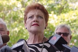 A tight head shot of Pauline Hanson speaking to reporters.