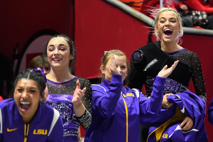 Olivia Dunne jumps in the air as she cheers on LSU Gymnastics teammates against Utah.