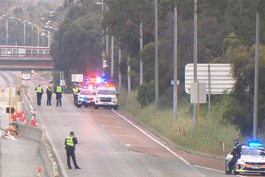 Freeway with police cars parked to the side 