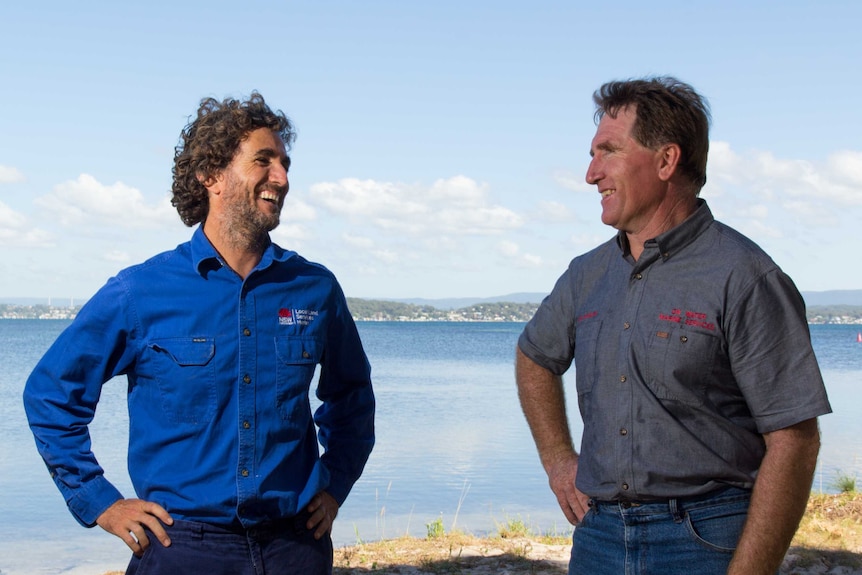 Brian Hughes and Des Maslen share a laugh next to Lake Macquarie.