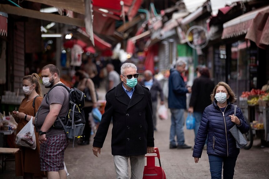 People at a market space with face masks.