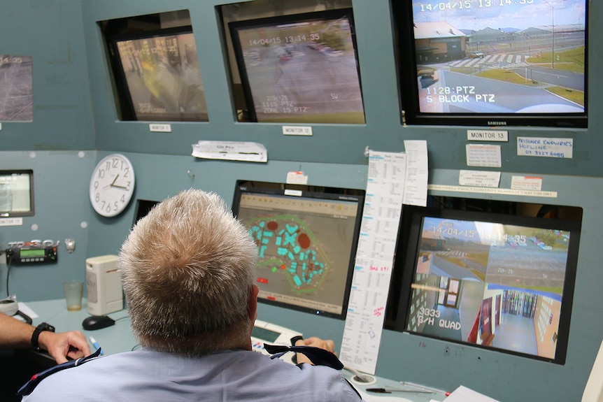 Prison guard monitoring CCTV at Woodford Correctional Centre, north of Brisbane