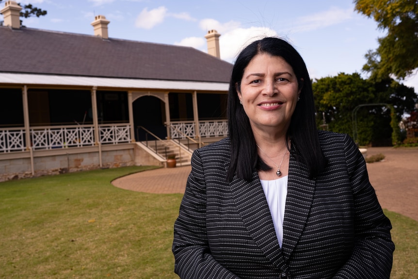 A woman next to a house